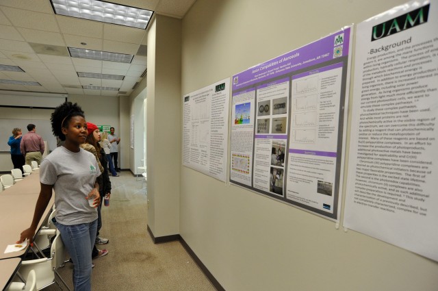 Kiara Newhouse examines her poster that describes her research on aerosols. Students presented their original research projects, some a result of off-campus summer internships.  Photo Courtesy of Media Services